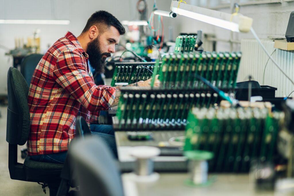 Electronics engineer working in a workshop with tin soldering parts